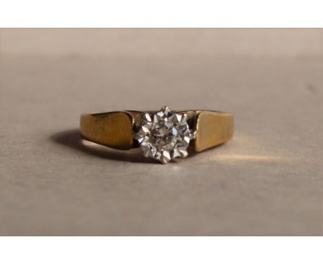 A solitaire diamond ring, the round brilliant cut diamond approximately 0.10cts to a white metal setting and 18ct yellow gold