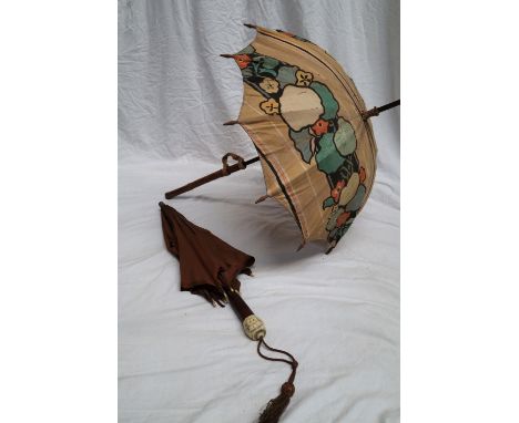 A carved bamboo handled parasol together with an ivory, bone and walnut handled and a walking stick