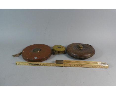 A Collection of Three Vintage Tape Measures and a German Folding Rule 