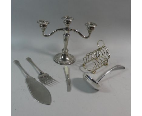 A Collection of Silverplate to Include Toast Rack, Fish Servers, Ladle, Three Branch Candelabra 