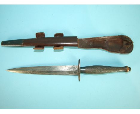 A WWII second pattern Fairbairn-Sykes fighting knife by Wilkinson, the black handle with 2" straight guard and double-edged b