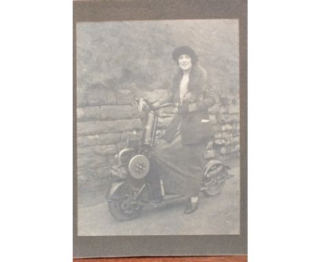 A 1920's photograph of a lady riding an Autoglider Scooter, 21 x 16cm, mounted on board. (First made in 1919, these front-mou