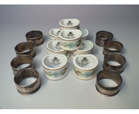 A COLLECTION OF EIGHT MATCHING SILVER PLATED NAPKIN RINGS, together with a collection of eight ceramic Aynsley 'Wild Tudor' n
