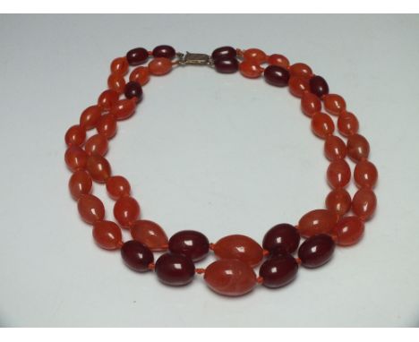 A VINTAGE DOUBLE STRAND AMBER STYLE GRADUATED BEAD NECKLACE, comprising a selection of cherry amber and polished agate hand k
