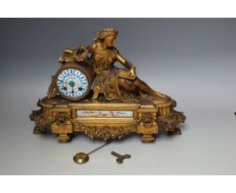 A FRENCH GILT METAL FIGURAL MANTEL CLOCK, with inset porcelain panels, the eight day movement striking on a bell, W 41 cm, H 