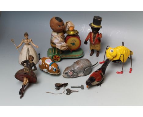 EIGHT VARIOUS EARLY AND VINTAGE CLOCKWORK TOYS