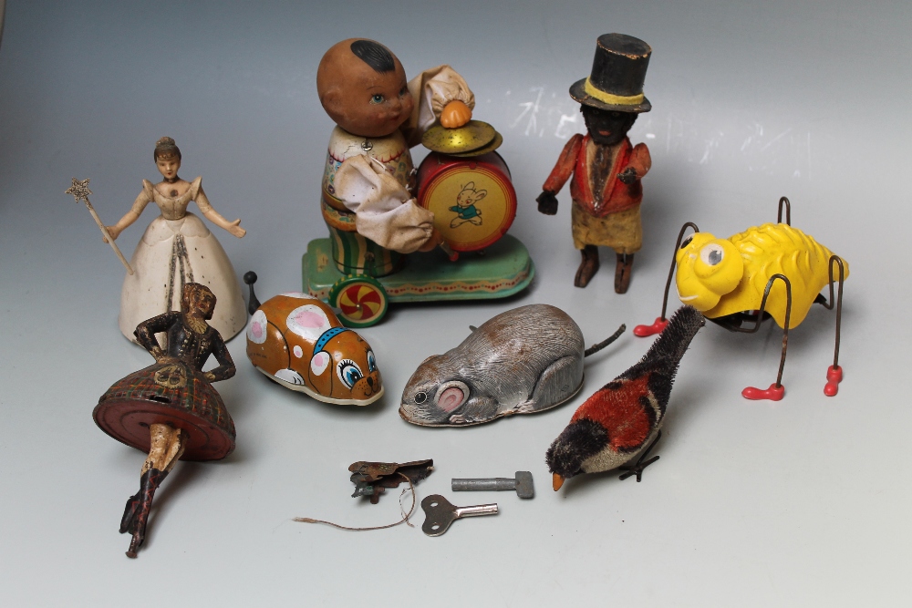 EIGHT VARIOUS EARLY AND VINTAGE CLOCKWORK TOYS