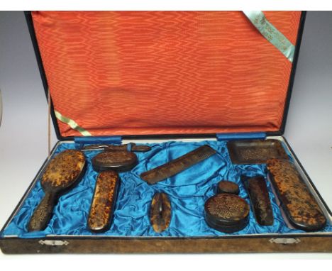 A BOXED VINTAGE TORTOISESHELL DRESSING TABLE SET, comprising eleven various items to include lidded pots, nail buffer etc.