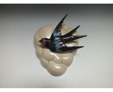 A CLARICE CLIFF WALL POCKET, in the form of cloud decorated in high relief with a swallow in flight, printed marks to reverse
