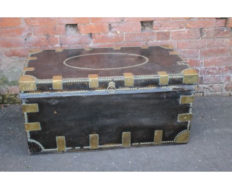 AN ANTIQUE LEATHER AND BRASS BOUND RECTANGULAR TRUNK, with brass studded detail, twin brass carry handles, W 110 cm  A/FCondi