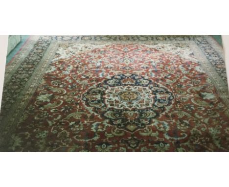 A CONTEMPORARY CENTRAL PERSIAN SILK GHOM CARPET, having a large central cartouche, floral scrolling detail on a mainly red gr