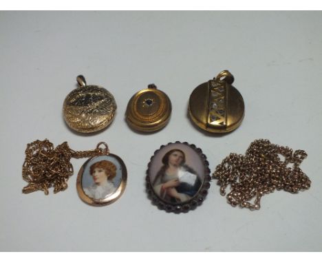 THREE VINTAGE YELLOW METAL PENDANT LOCKETS, together with a memorial pendant having hair panel to reverse, a half portrait br