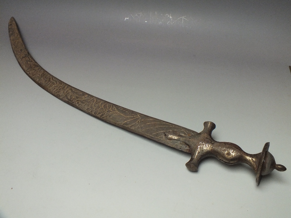A MIDDLE EASTERN CURVED SWORD, with shaped metal grip, the curved blade
