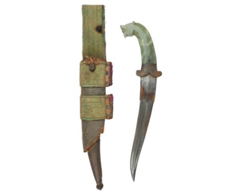 An Indian jade hilted dagger (khanjar), flamboyant double edged blade 9.5 in. with two broad fullers forming a medial ridge t