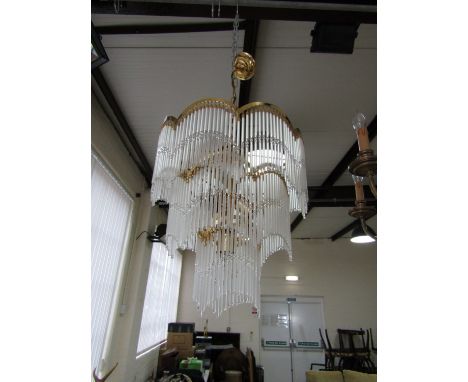 A contemporary three tier gilt brass and glass chandelier 