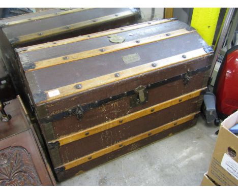 A late 19th / early 20th Century dome top trunk with affixed Grenadier Guards brass badge