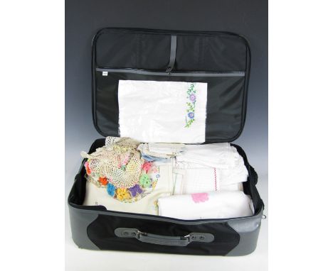 Sundry vintage hand embroidered textiles contained within a modern suitcase 
