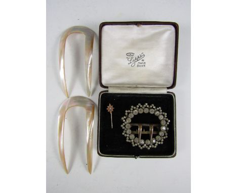 Late 19th / early 20th Century dressing accessories, including a paste buckle, two mother of pearl hair pins, and a gilt meta