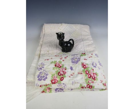 A late Victorian patchwork quilt in pale pinks and blues, in a banded design of diamond patchwork, interspersed with hand-qui
