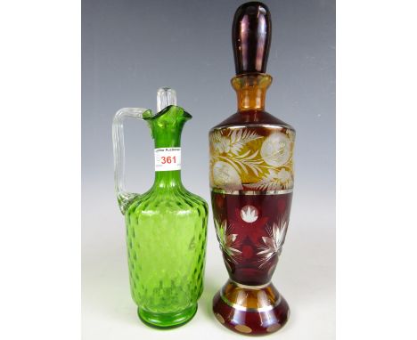 A 19th Century ruby and amber etched glass decanter together with an emerald green glass jug