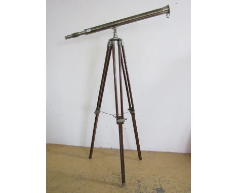 A large refracting terrestrial telescope with tripod 