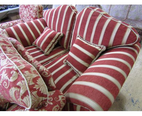 A contemporary two seater sofa upholstered in a coral and gold Regency stripe