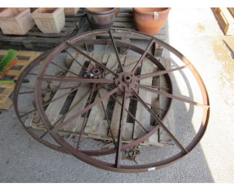 TWO VERY LARGE VINTAGE IRON WHEELS ONE NAMED FOR NICHOLSONS NEWARK NUMBERED 925X PROBABLY FROM VINTAGE AGRICULTURAL IMPLEMENT