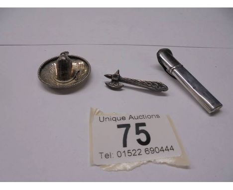 A silver sombrero pendant, a silver axe brooch and a silver button hole holder 10 grams.