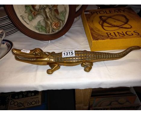 A brass crocodile nut cracker