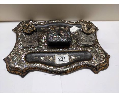 A Victorian papier mache' and mother of pearl inkstand.Tray sits flat and in good condition for age.Small chips to the ink bo
