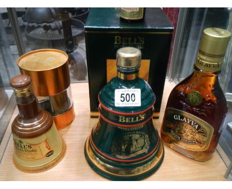 Two Bell's whisky bells with contents, a Glayva Scotch liquor and other whisky.
