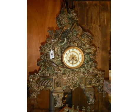 A Victorian cast iron 8 day clock with bronzed finish featuring horse, rider, dogs etc.,