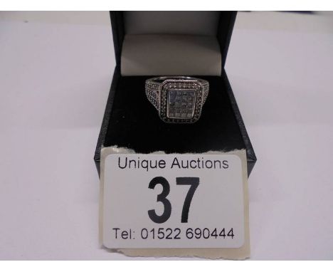 A 1 ct plus square shaped diamond ring, 6.9 grams. size L.