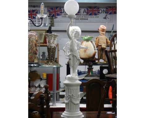 A floor standing lamp in the form of a cherub on a pedestal. COLLECT ONLY.