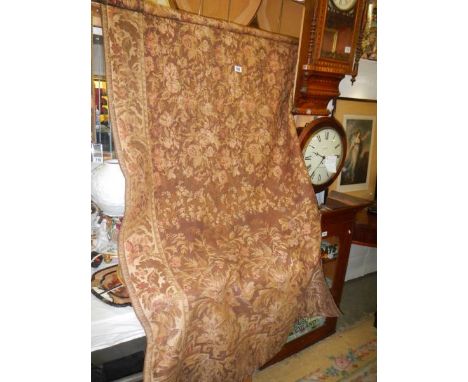 A long tapestry wall hanging featuring flowers.