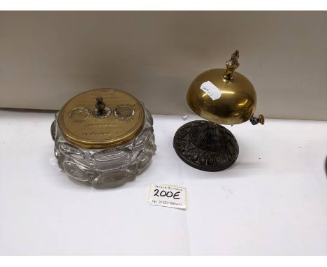 A brass shop bell and a glass inkwell with brass top.