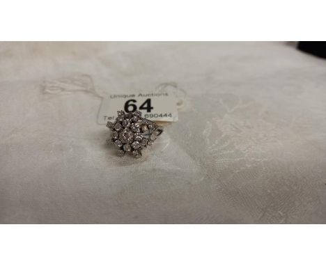 A diamond cluster ring, approximately 1.75 carats total in a starburst design, 14ct white gold set, size N, 7.6 grams.