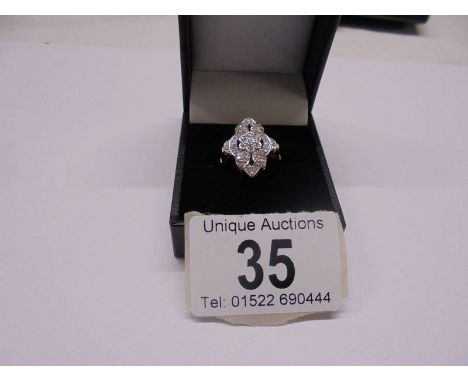 A five section floral white gold and diamond ring, size N half, 5.5 grams.