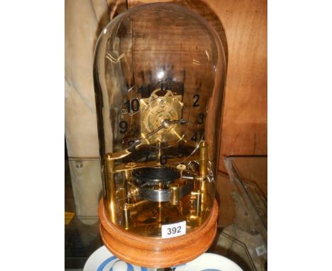A late 20th century electric magnetic hip toggle great balance wheel clock, will need new batteries (small chip in glass dome