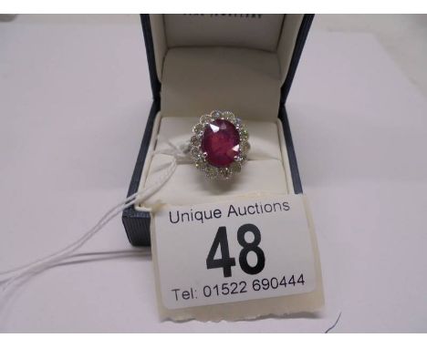 A 6.5 carat oval ruby platinum and diamond ring, size N half, 8 grams.Good condition.