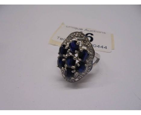 A large white gold sapphire and diamond ring, size M half, 5.6 grams.Hallmarked.No visible wear.