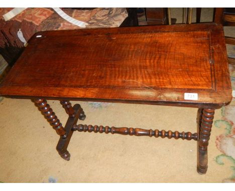 An early 20th century side table with bobbin turned legs and stretcher.