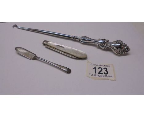 A silver pen knife, a silver jam spoon and a silver handled button hook.