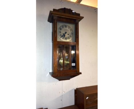 A 1930's oak wall clock. COLLECT ONLY.