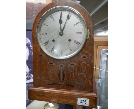 An 8 day graduated quarter striking bracket clock on 2 gongs, silver 7" dial, working order, with key.&nbsp; Oak case with in