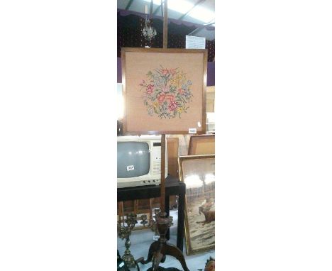 A victorian mahogany pole screen with floral tapestry panel