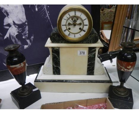 An 8 day marble clock garniture.Side urns have chips to stepped bases in places.Clock is working.Marble has some small chips 