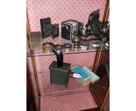 A small magic lantern and a quantity of camera's.