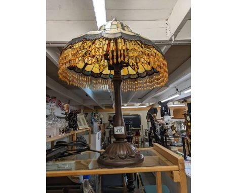A table lamp with Tiffany style shade. COLLECT ONLY.In good condition.Total height 59cm approx.Shade diameter 43cm approx