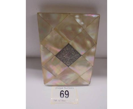 A mother of pearl card case with silver cartouche.